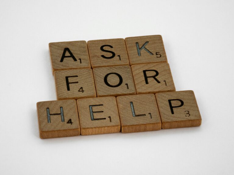 Scrabble letters spell out "Ask for help"